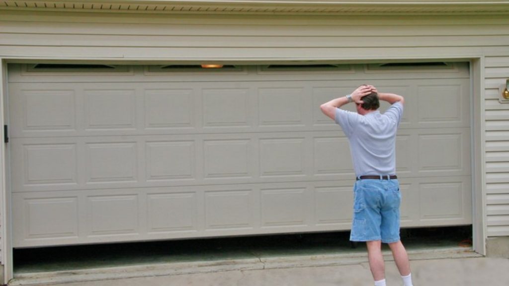 A homeowner looking as his garage door closes