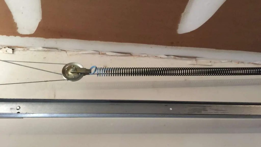 An extension spring connected to a garage door cable