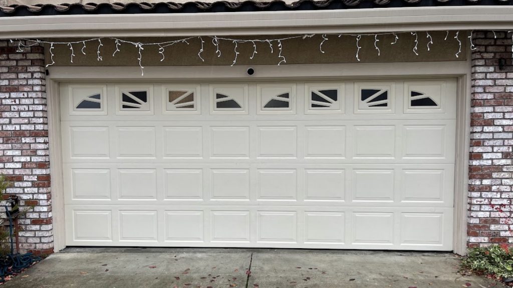 A sectional garage door made of steel. Strong materials help prevent garage door break-ins.