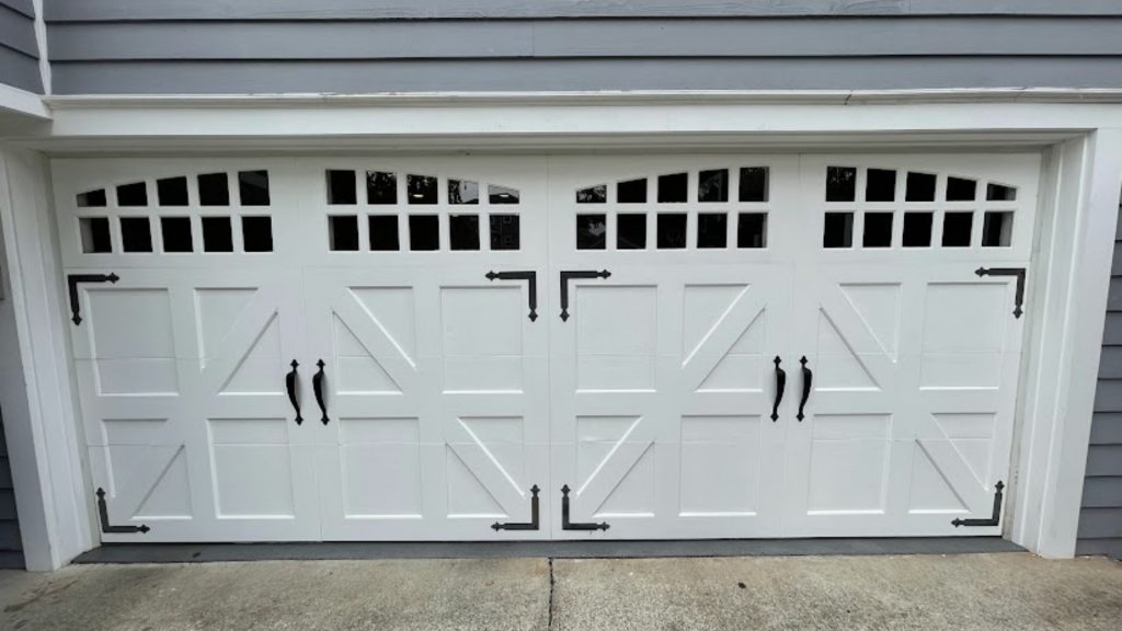 A two-car door with garage door decorative hardware