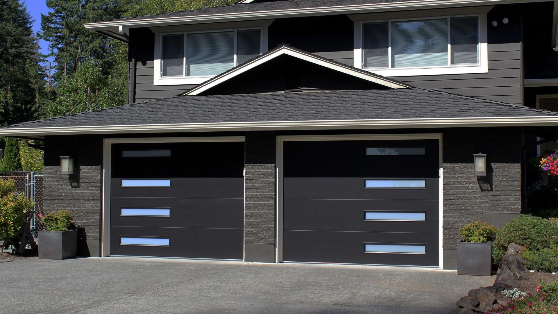 A house with black colored garage doors