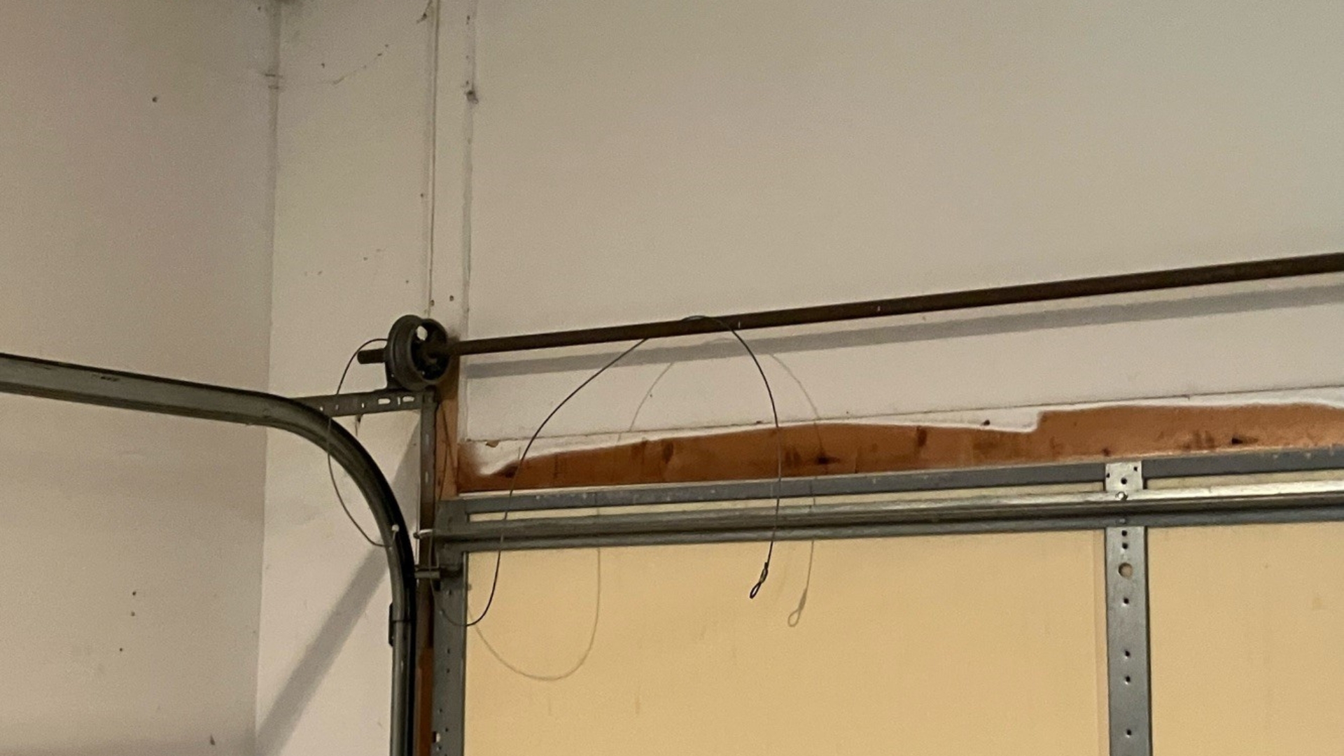 A garage door cable coming off the drum