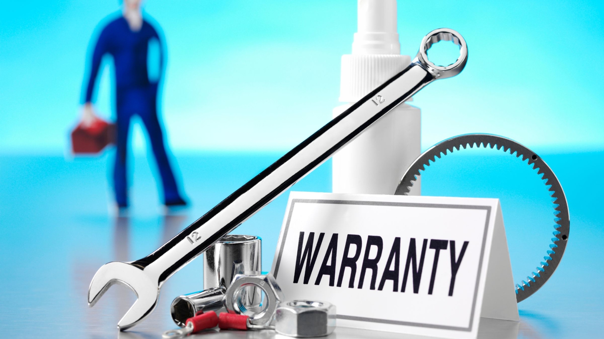 An image of garage door parts and tools with a card that says warranty