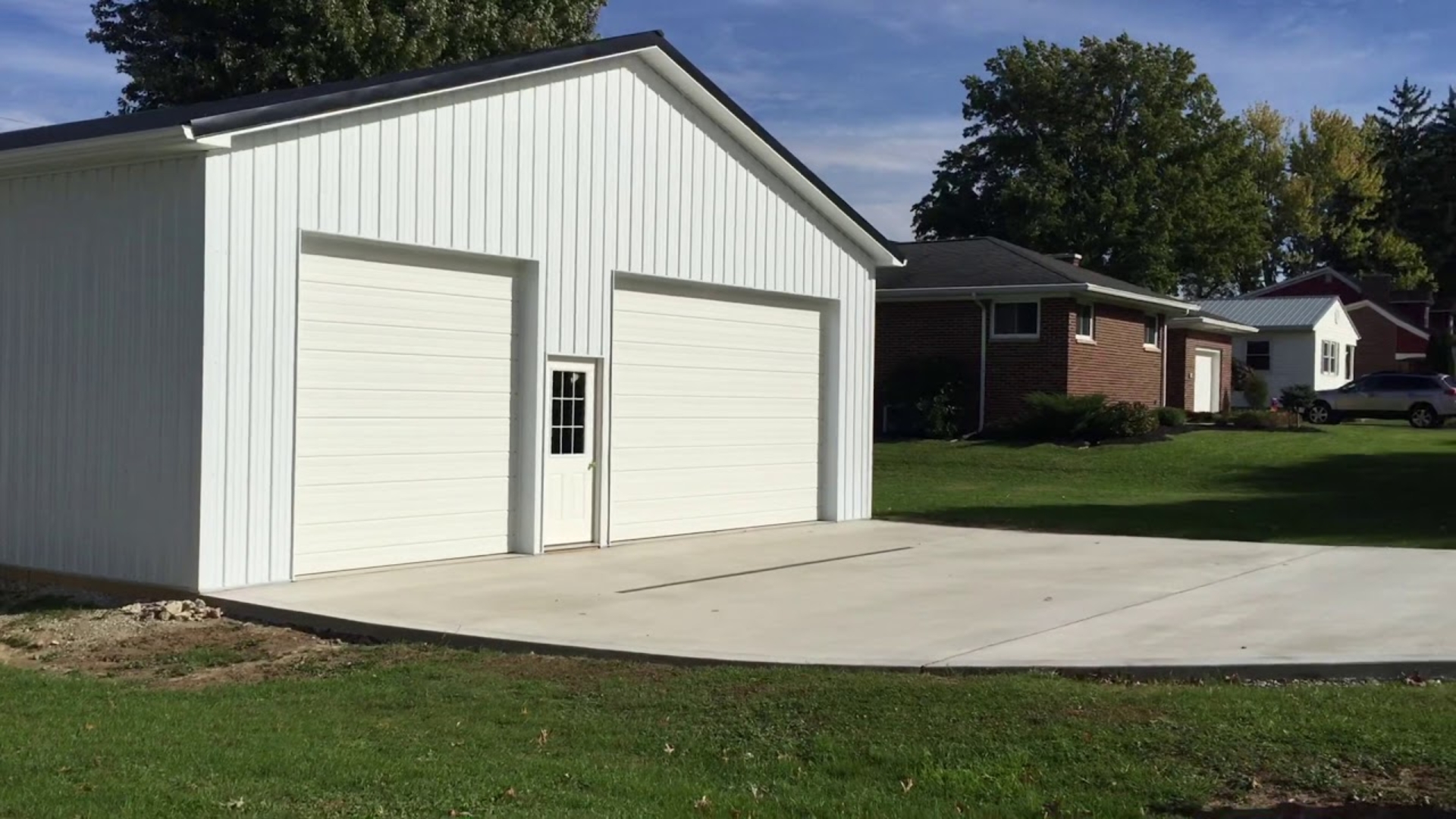 Residential property with two oversized garage door setups.