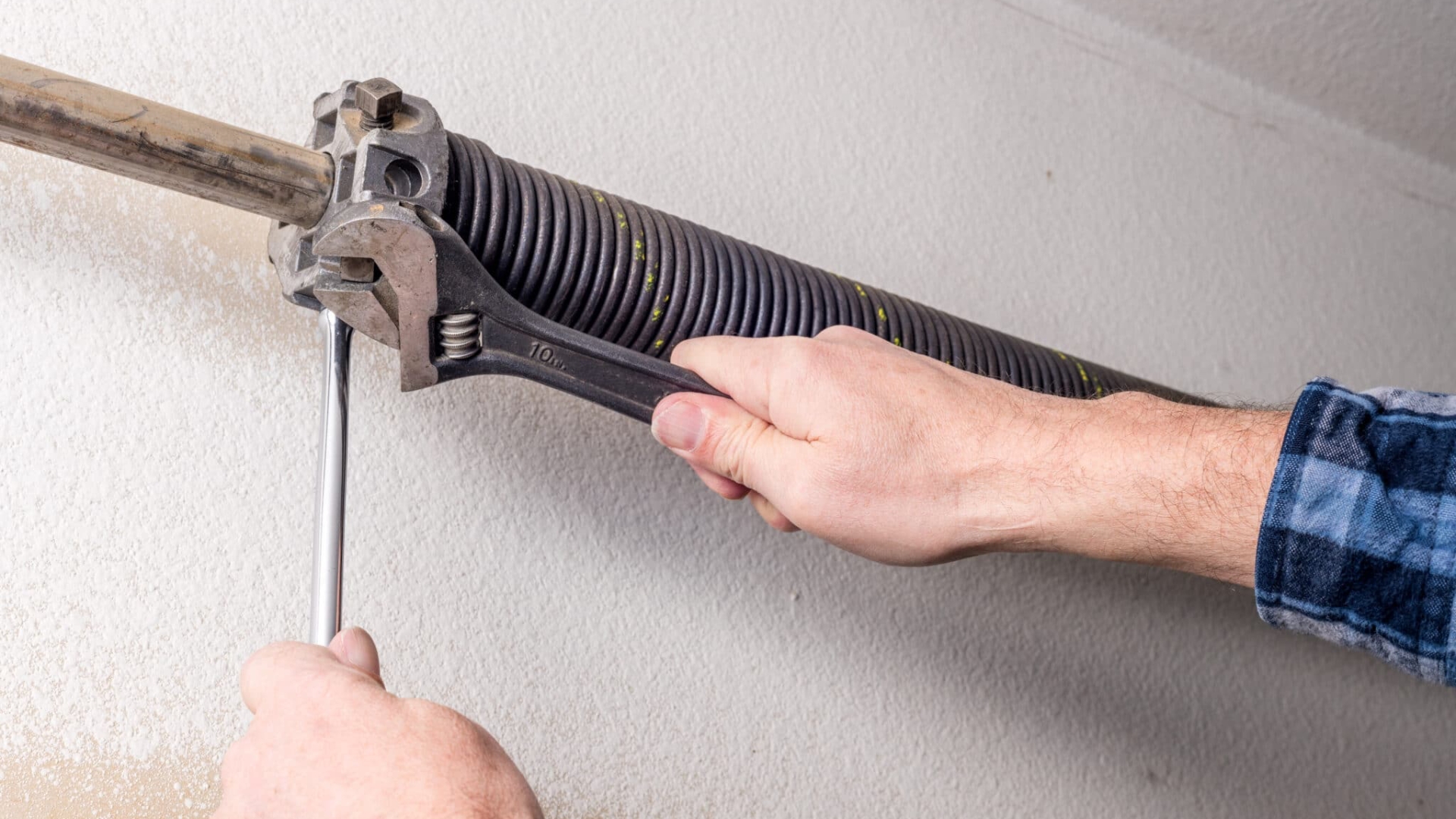 Adjusting the spring tension to address a slow garage door operation.