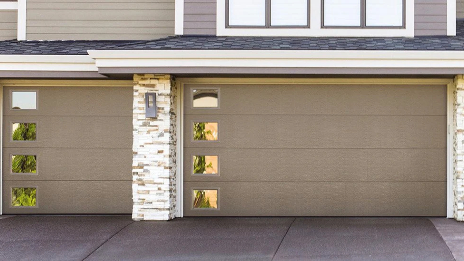 Double garage doors with a sleek finish and modern window placement.