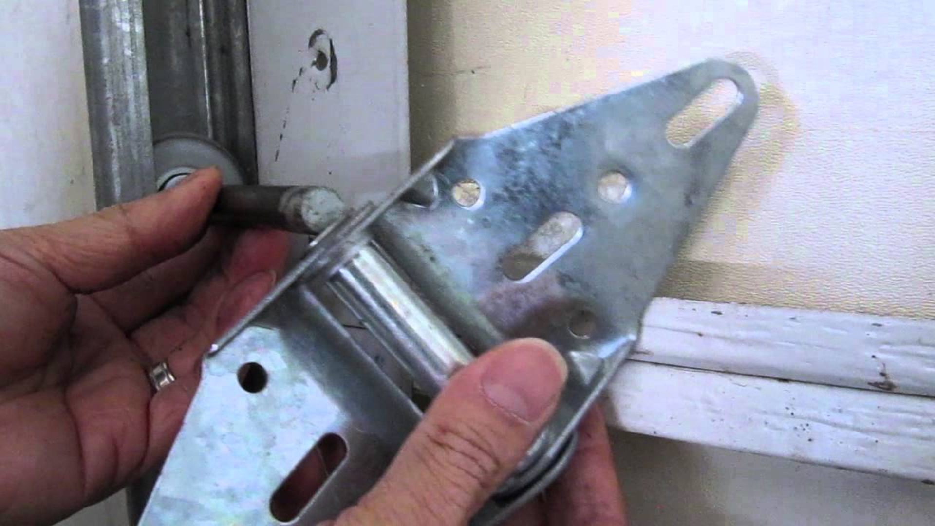 Replacing worn-out hinges to prevent squeaky garage doors.