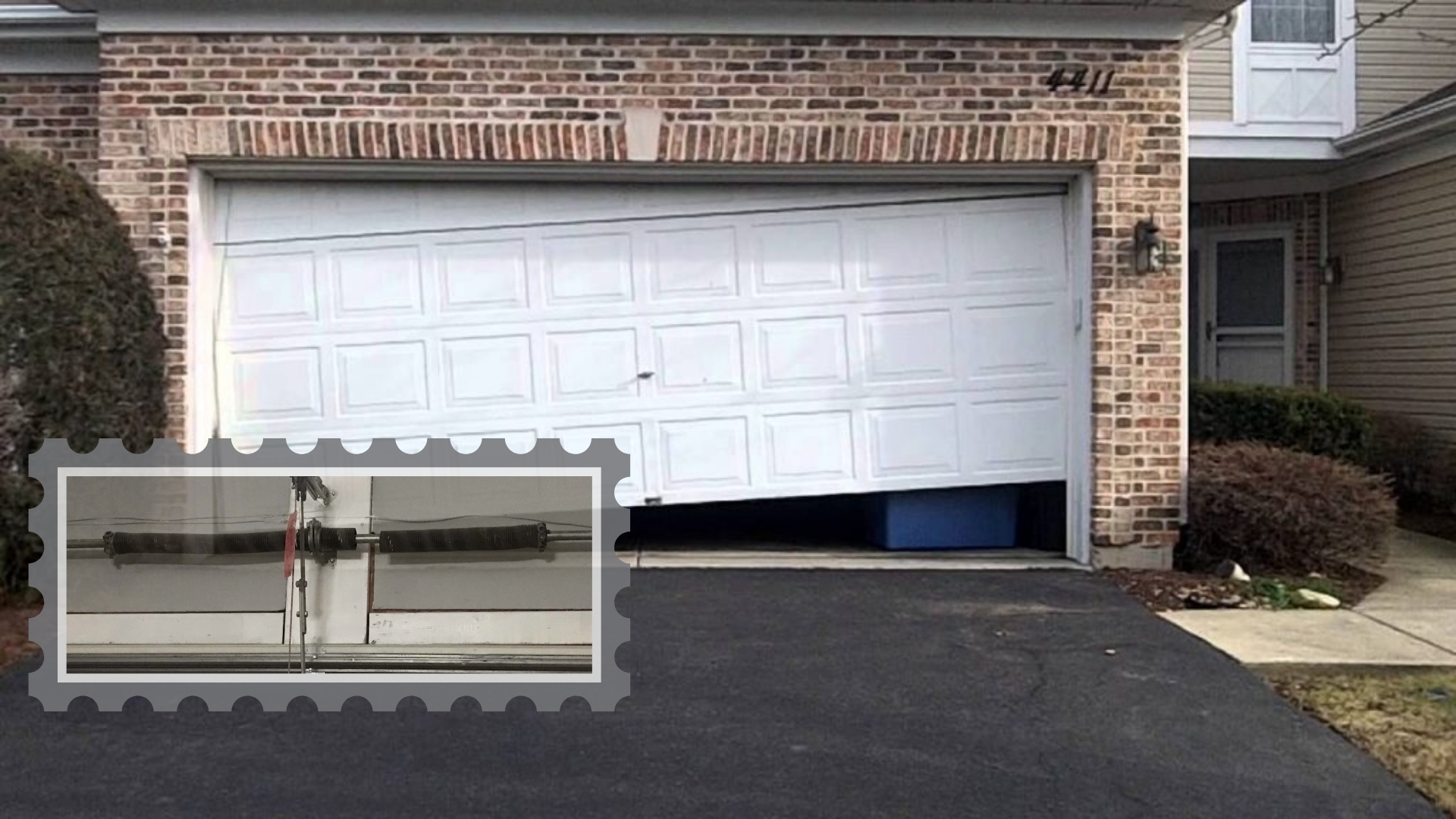 A garage door stuck at an angle due to a broken spring, requiring emergency garage door repair