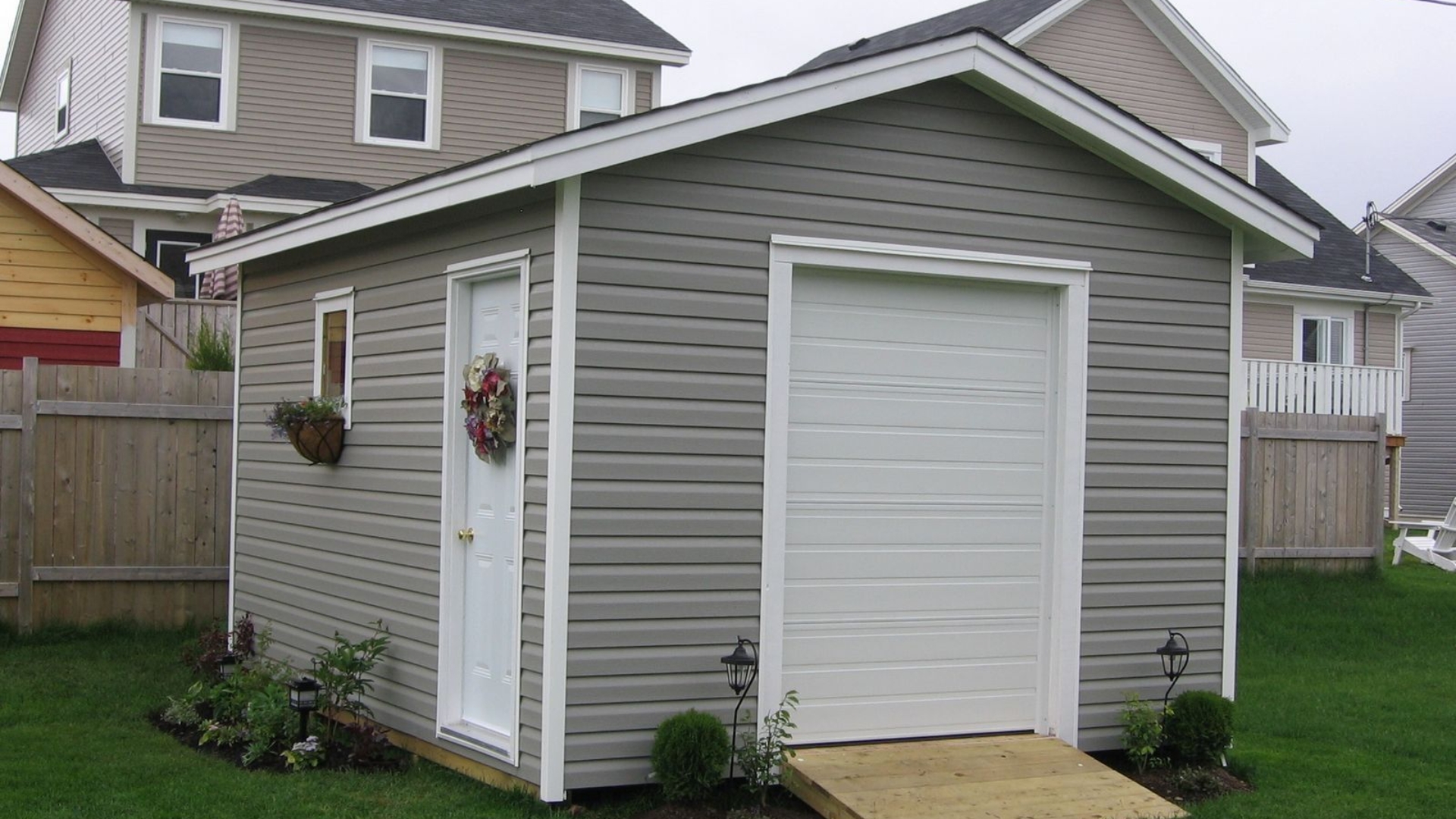 A small garage door on a detached backyard garage.