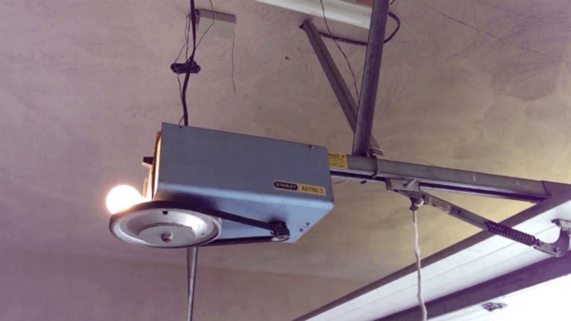 An old garage door opener system that needs urgent repair.