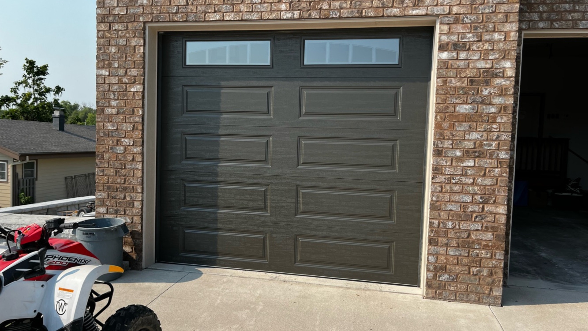 Modern retrofit garage door with top window panels.