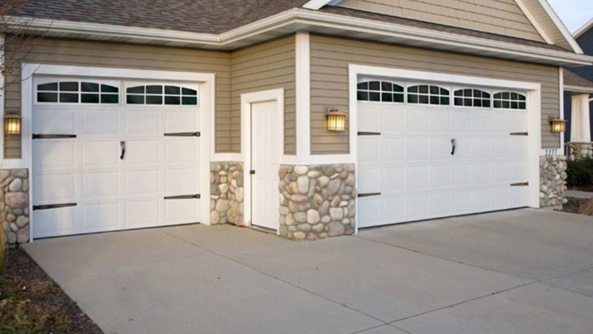 Residential home showing garage door modifications with window inserts
