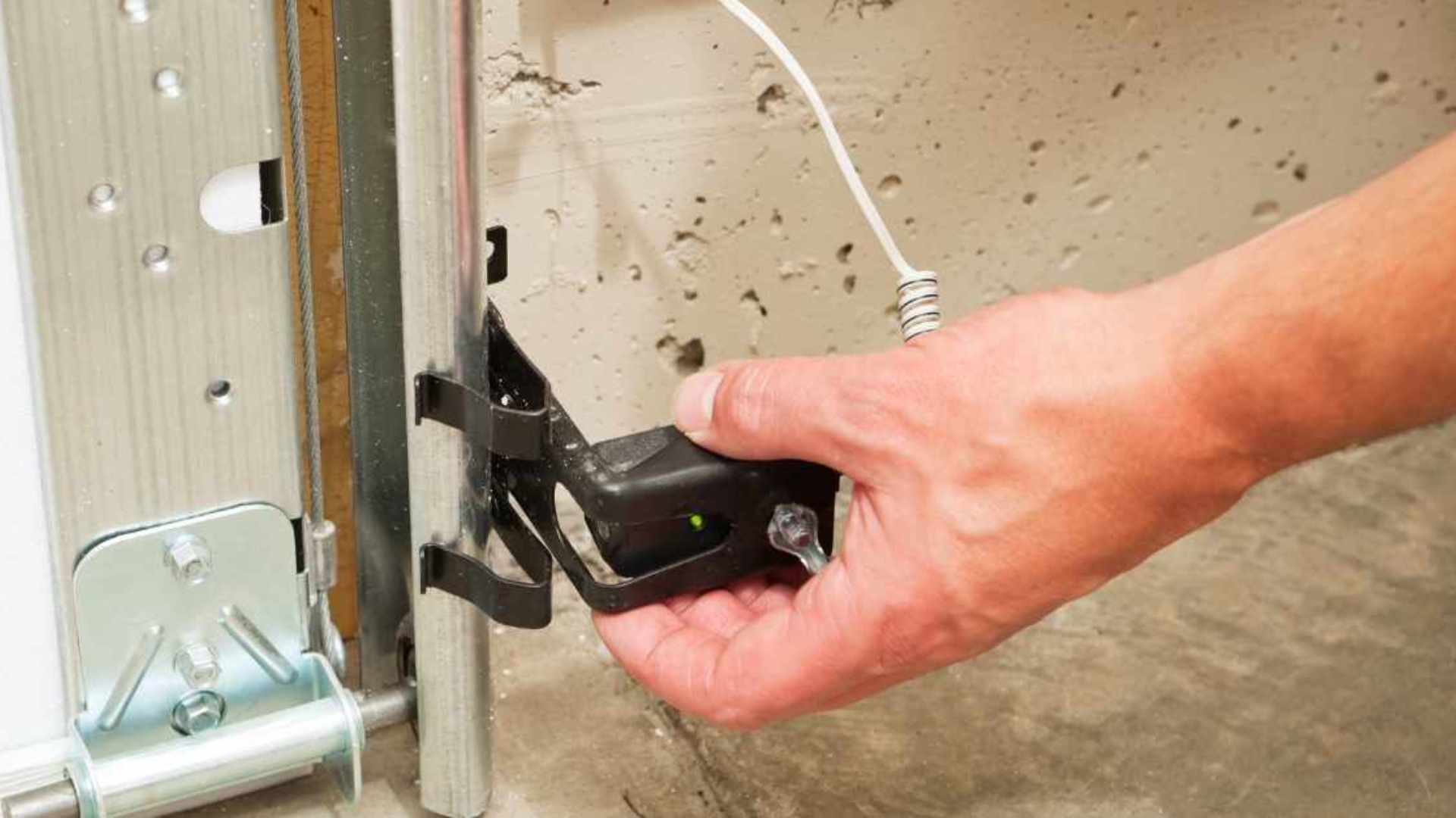 Fixing garage door opener light issue by cleaning and adjusting the motion sensor near the track